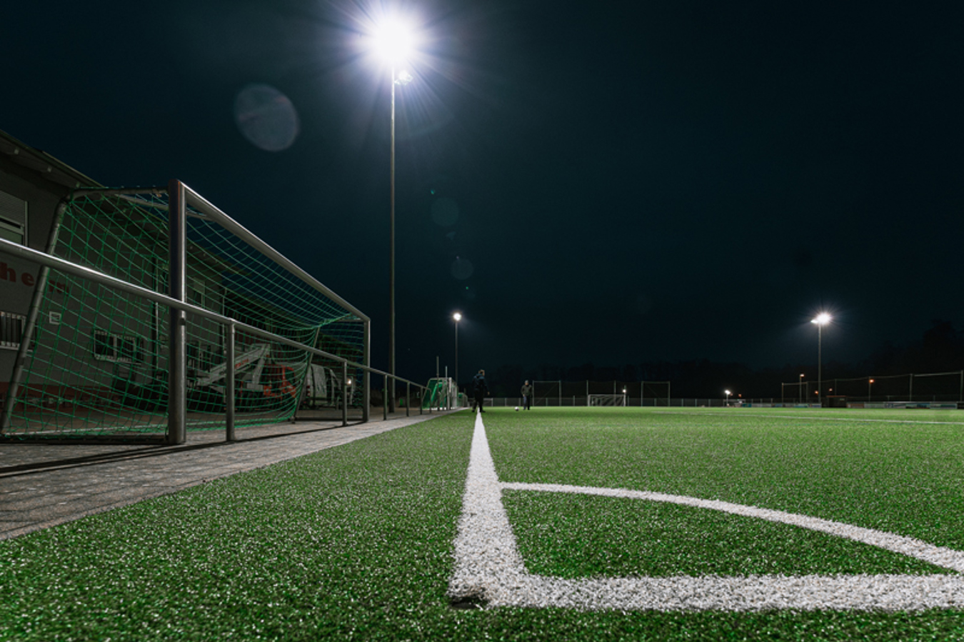 Retrofit LED sports lighting at SV Gottenheim providing uniform illumination across the football pitch using existing masts.